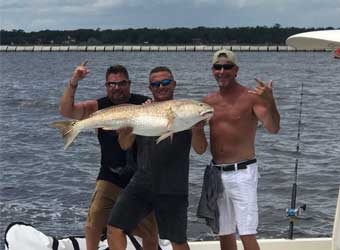 Three Men with a Fish | Family-Friendly Fishing Charters in Jacksonville, FL - Fish Hunter Charters