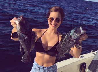 Woman Holding Two Fish