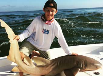 Boy Holding Shark
