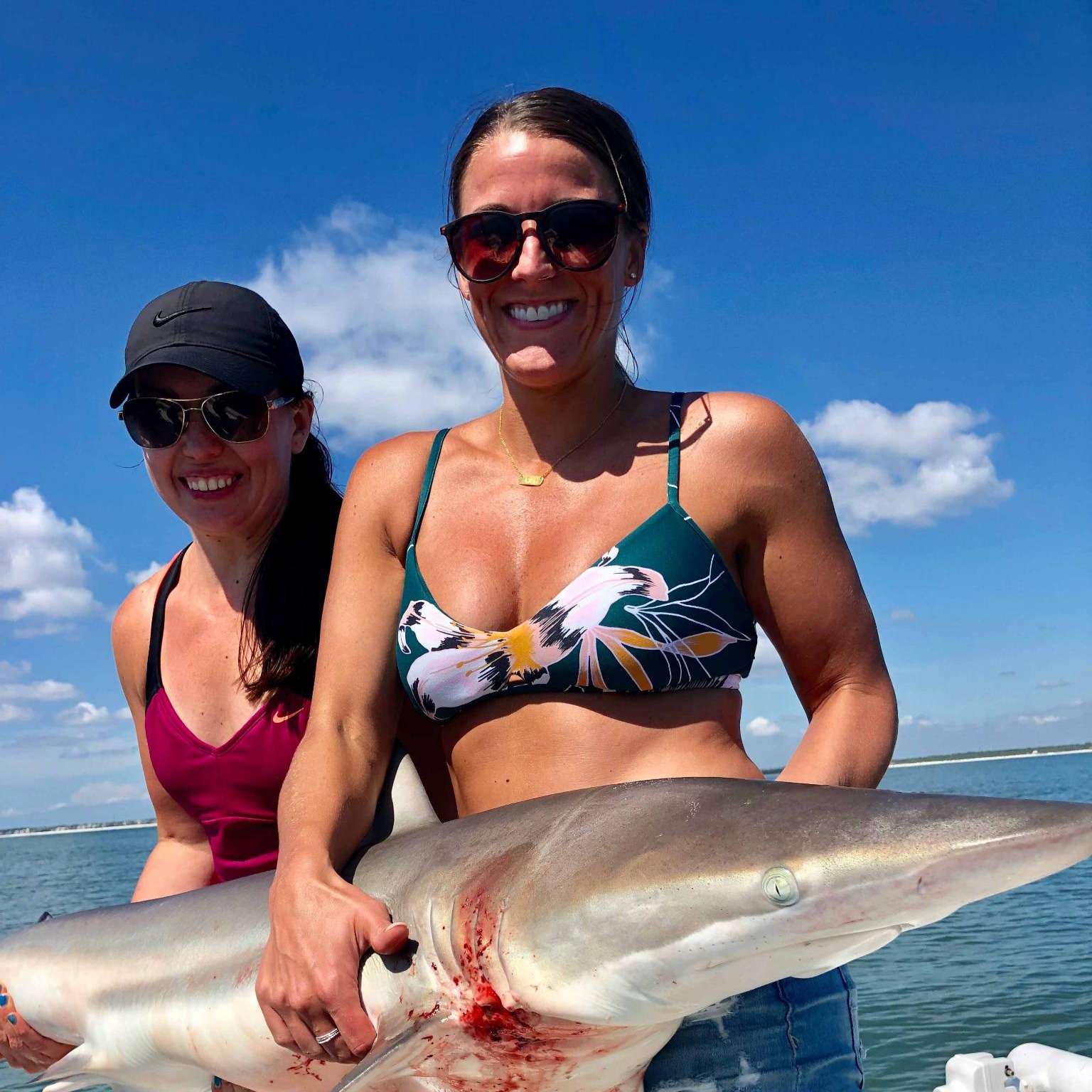 Girls Holding a Shark | Saltwater Fishing in Jacksonville, FL - Fish Hunter Charters